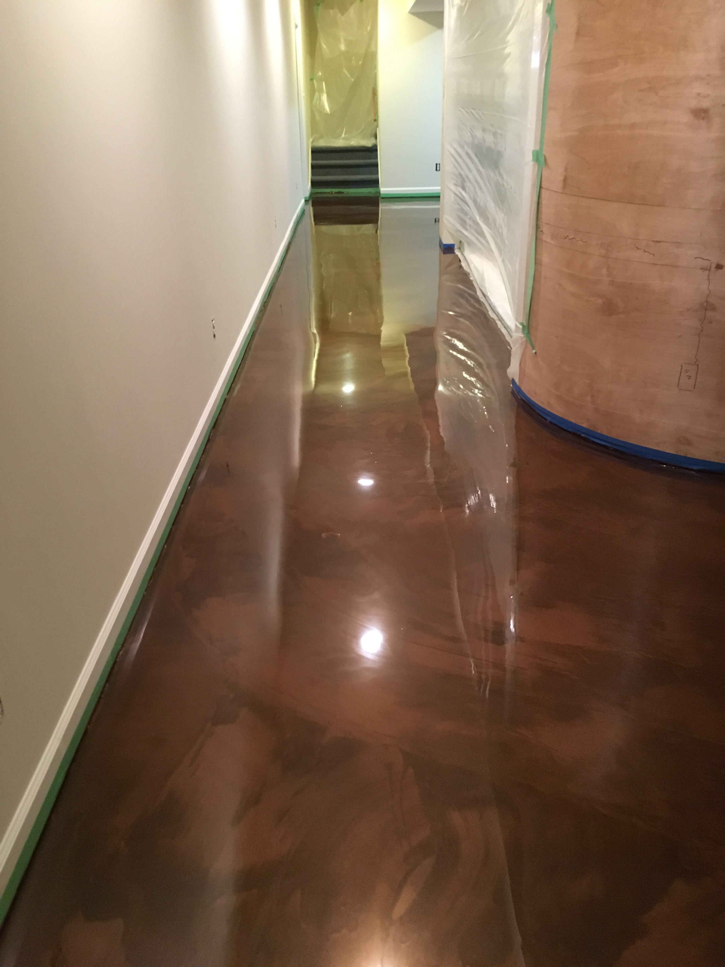 Garage epoxy coating with white cabinets and organized storage